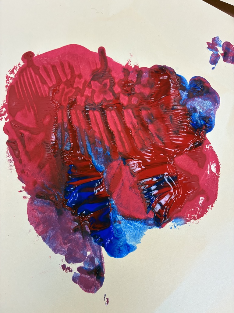 red and blue paint mixing into purple