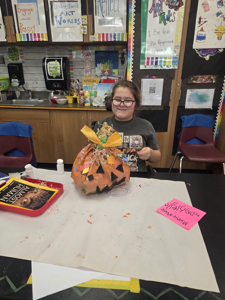 Student finishing up her pumpkin