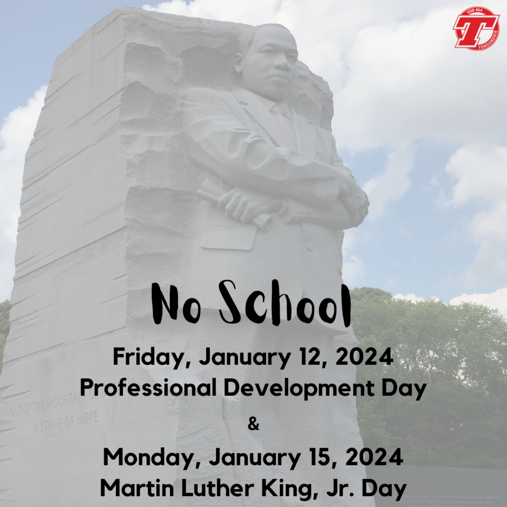 statute of Martin Luther King Jr carved into stone on a background of green trees, blue sky and white puffy clouds