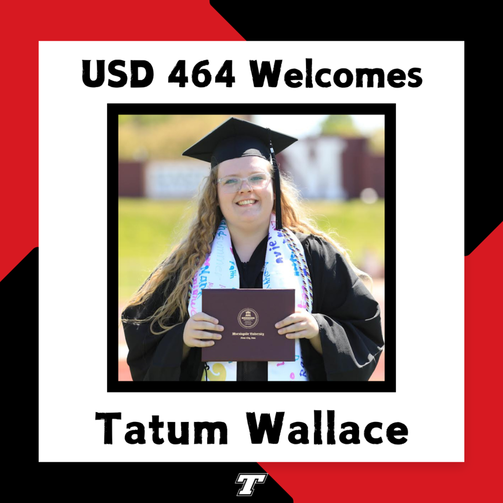 Tatum Wallace wearing black cap and gown with white sash, holding her diploma in a dark red leather bound folder