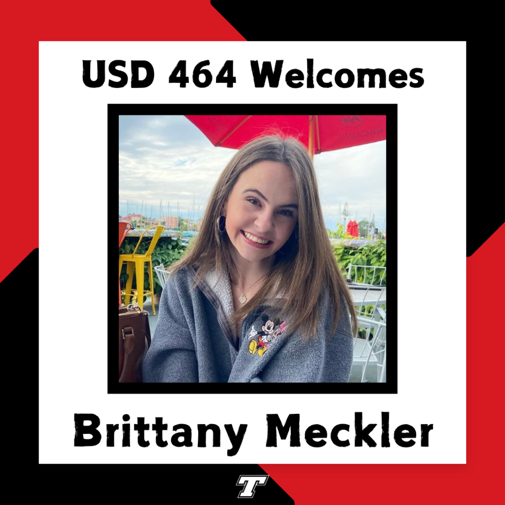 Brittany Meckler wearing a gray quarter zip sweatershirt with Mickey Mouse on it; red and black border around her