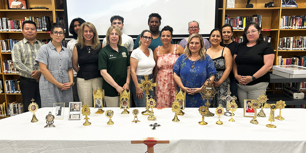 Group photo of Chaminade staff and attending with the display of sacred relics