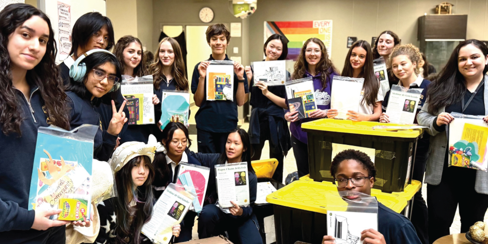 A group of students holding the , Crafting For A Cure kits. 