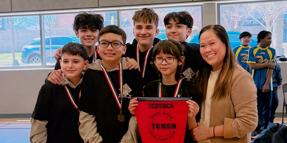 Photo of Precious Blood chess students with their medals and championship banner