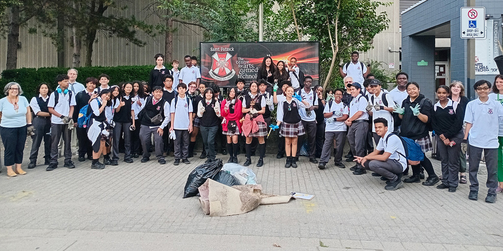 Group photo of St. Patrick students and staff after the cleanup with the bags they filled