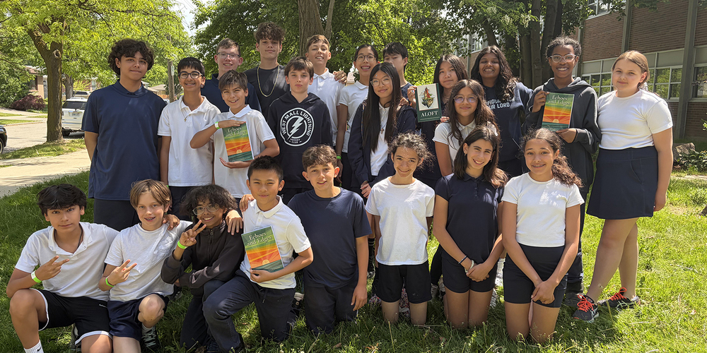 Group photo of Transfiguration students holding up copies of the book their work was published in