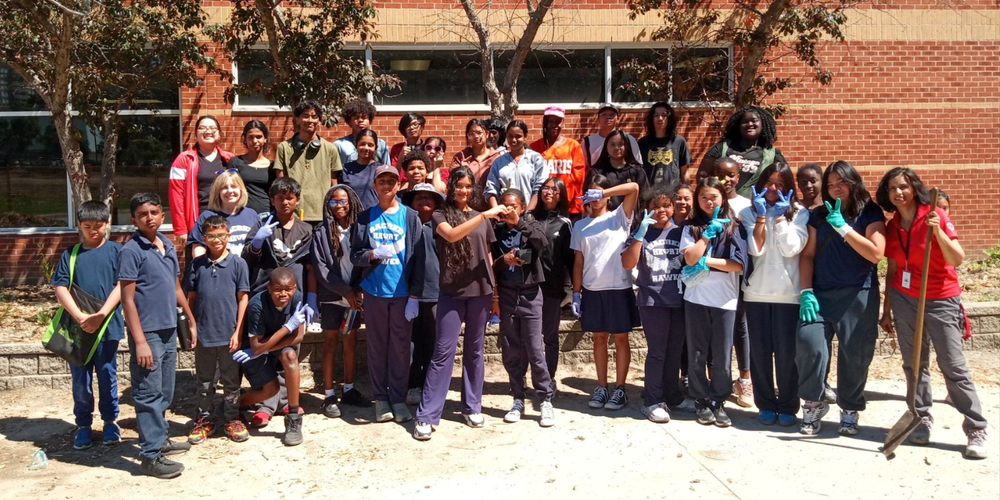 A large group of children in front of a school