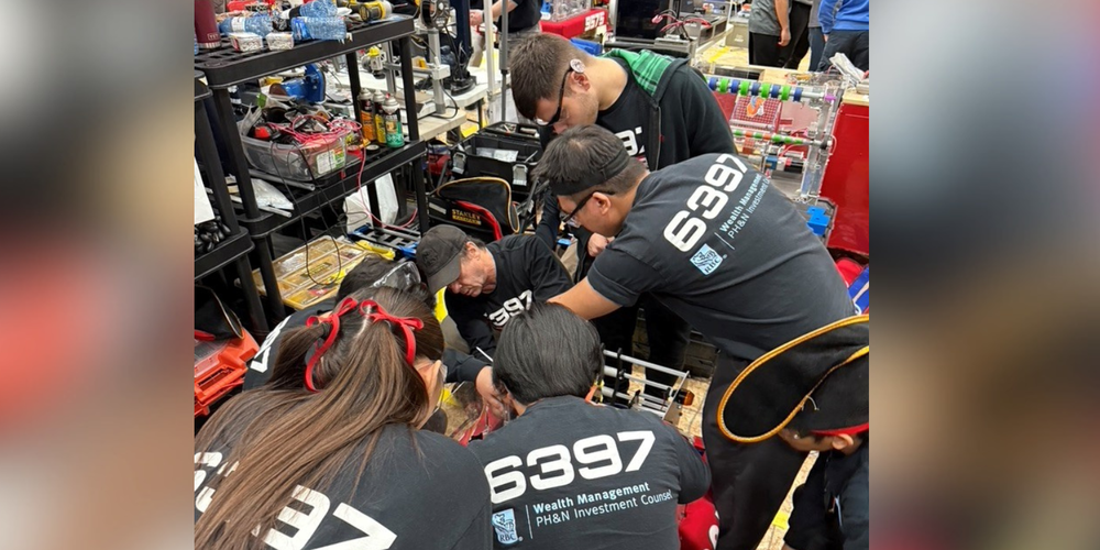 People working on something mechanical