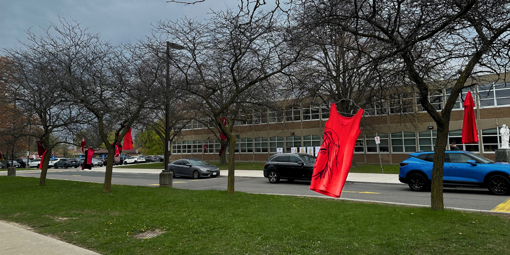 Red dresses hanging from trees