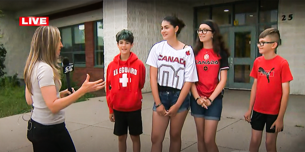 Screenshot from the video of four St. Timothy students being interviewed in front of the school by a CP24 journalist