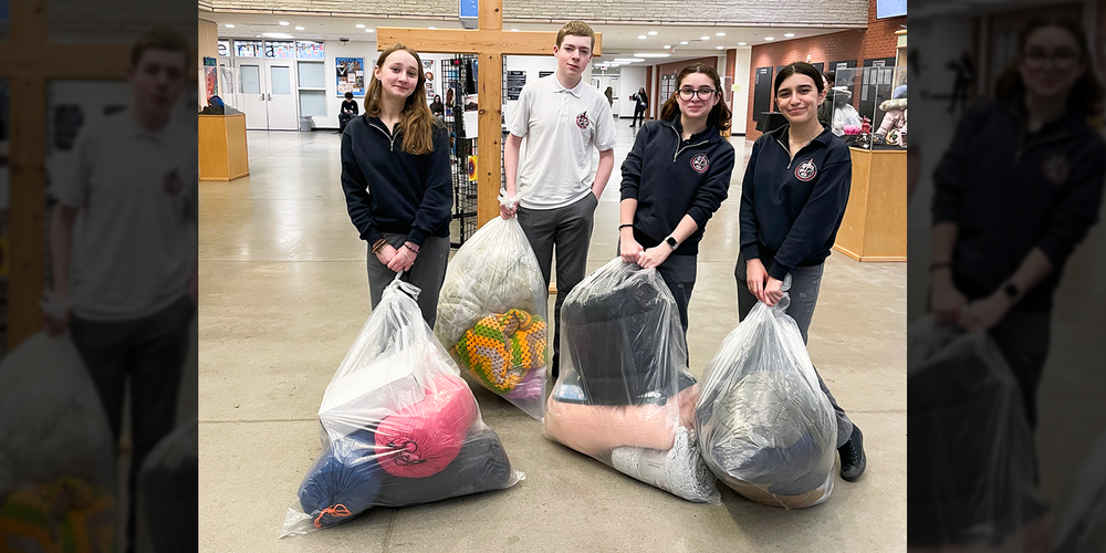 Photo of four Redmond students with the items they have collected