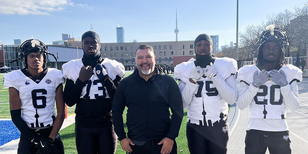 Group photo of JCM student athletes with their coach