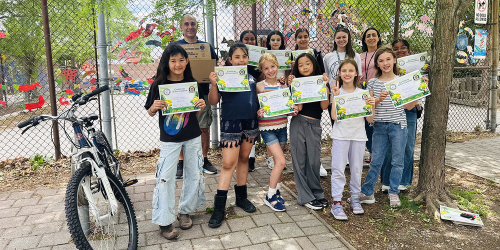 Group photo of St. Cecilia students and staff with the achievement certificates