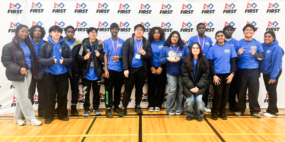 Group photo of SMTCA robotics team with their medals and trophy