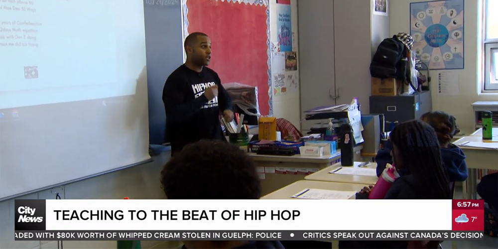 Screenshot of City News video with the caption "Teaching to the Beat of Hip Hop", which shows Michael Grandsoult educating St. Maria Goretti students through rap verses