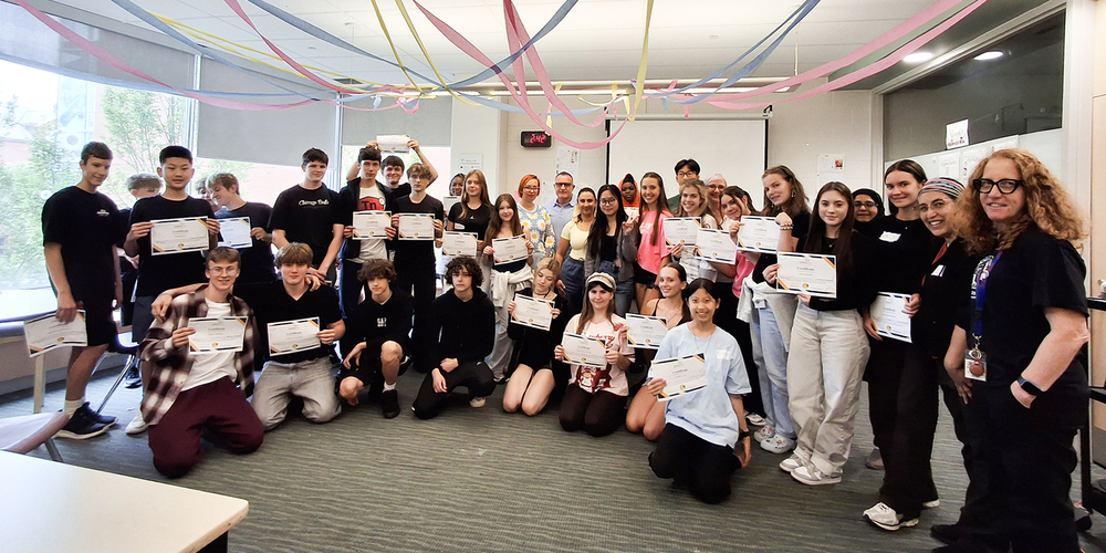 Group photo of attendees to the Newcomer Orientation Week program, including students and staff