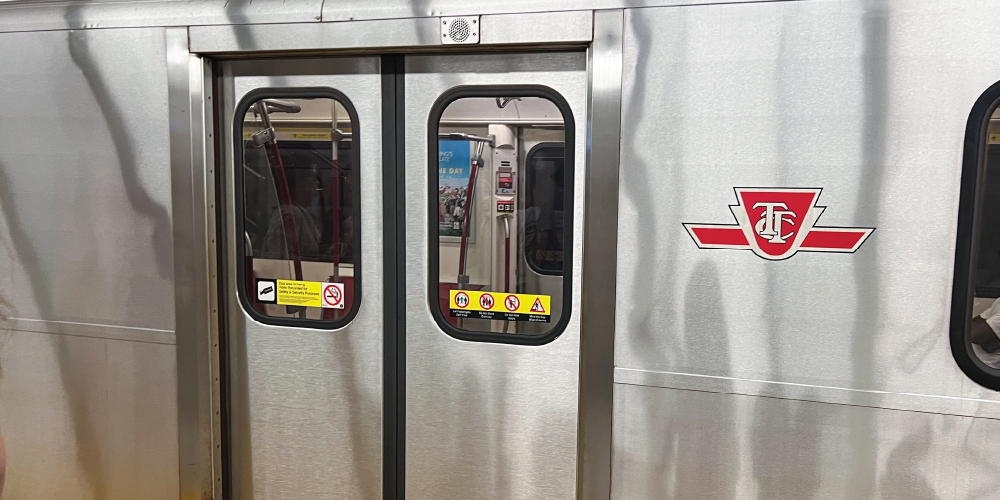 An image of a subway cart showing the TTC logo and subway door.