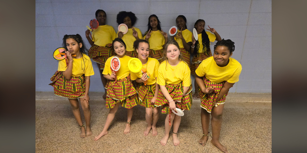 Little girls posing in yellow traditional clothing. 