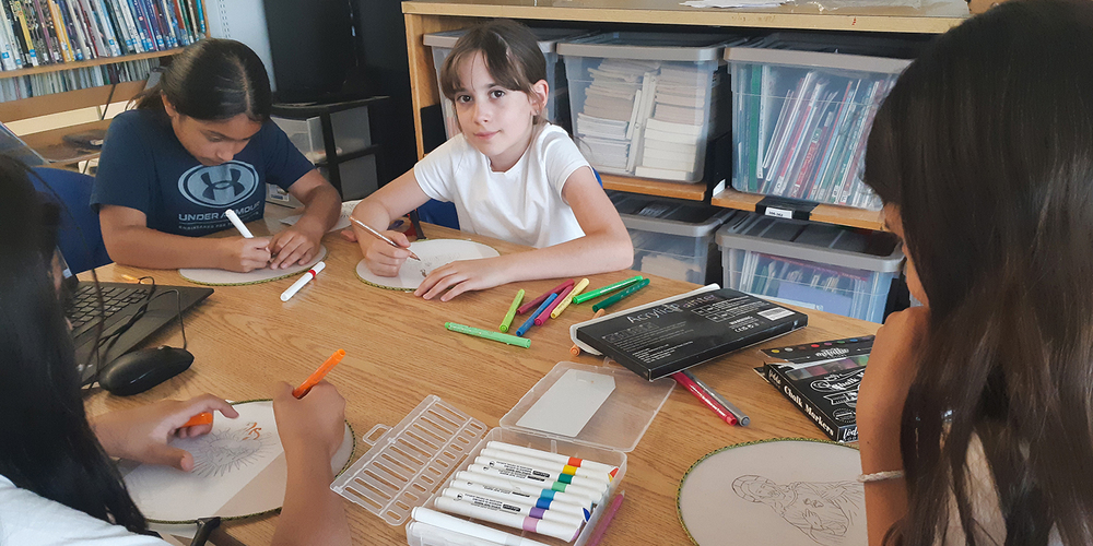 Photo of students working on their keepsakes together