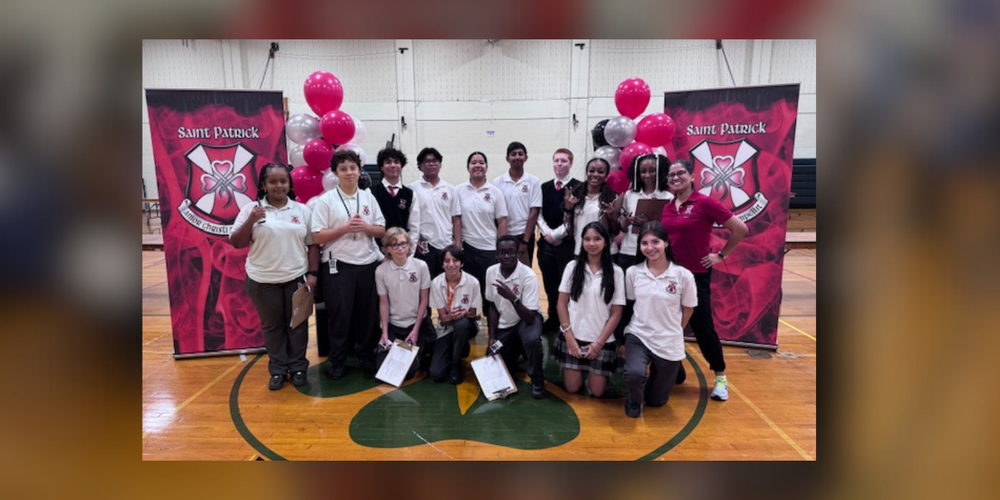 group photo of students in uniform in a gym