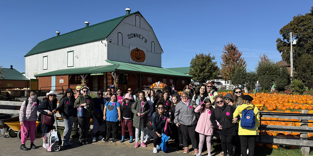 Group photo of Loretto College School students and staff in front of Downey's Farm next to the pumpkin patch
