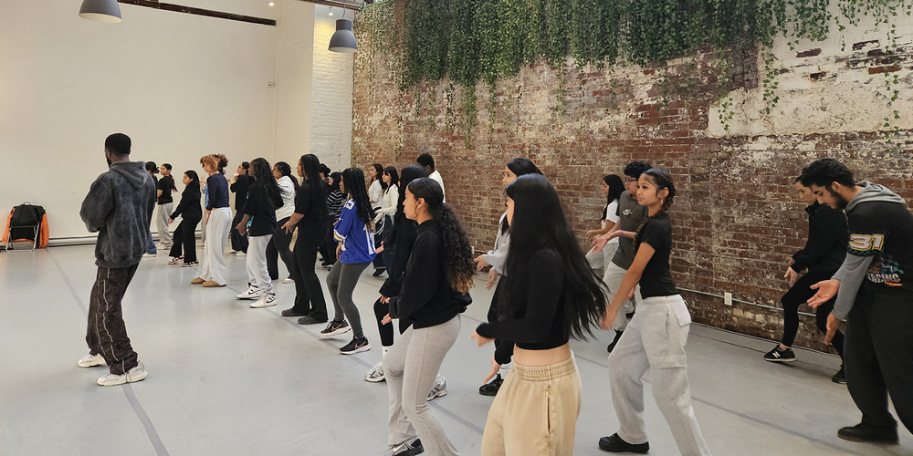 Photo of SJOA students dancing with Trevino Williams at the Hip Hop Workshop