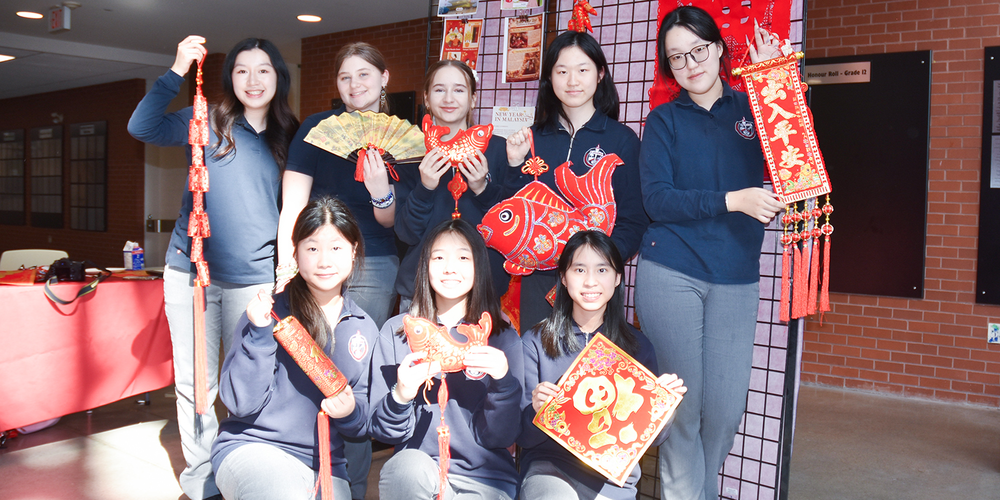 Photo of Redmond friends with Lunar New Year decorations and ornaments in red and gold
