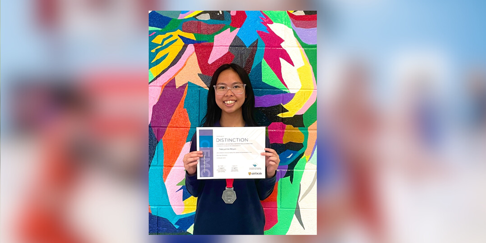 student holding a certificate