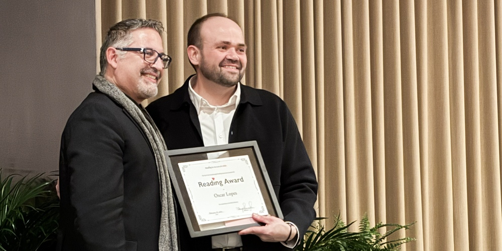 Photo of Oscar with his award standing with Superintendent Caccamo