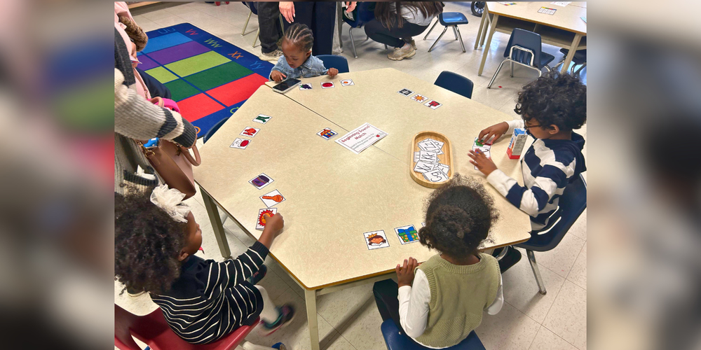 Children playing a game around a table. 