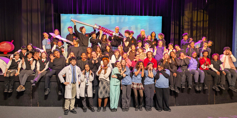 Large group photo of students on a stage
