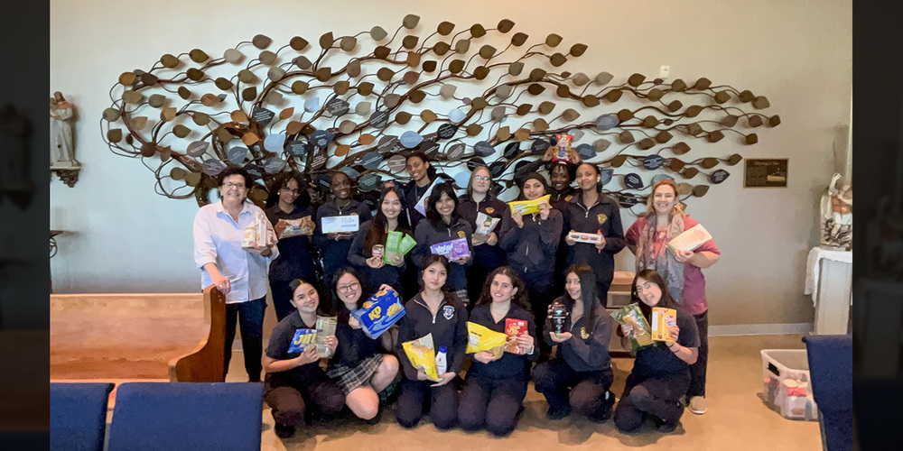Group photo of Loretto students and staff with the food items collected and donated