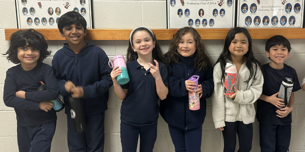 6 little kids holding water bottles