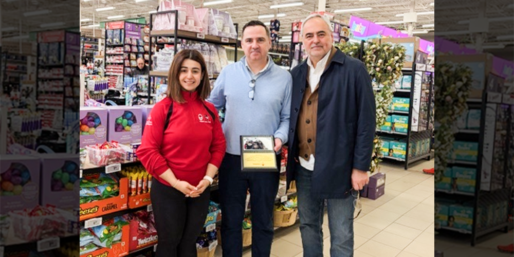 Photo of Michelle Bottos presenting David Hicks with a commemorative plaque on behalf of the St. Paschal Baylon community