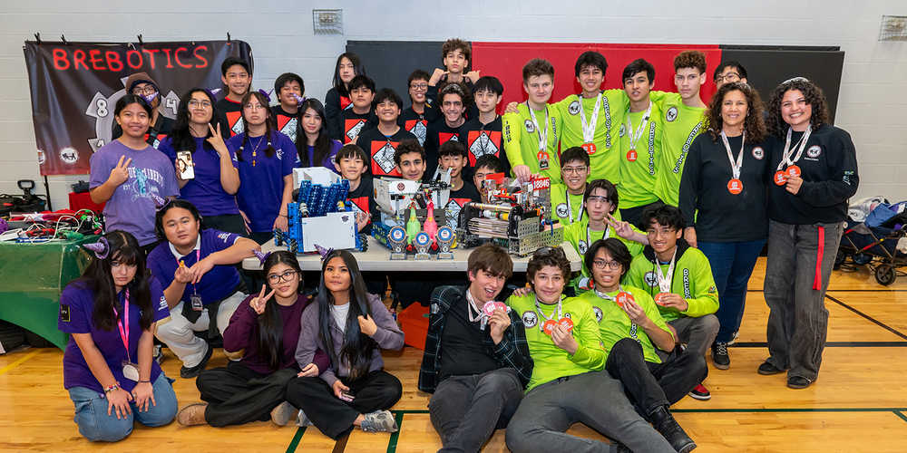 Group photo of 24418 Canoe, 18846 Brebotics, and 27631 Bewitched teams together with their medals and projects