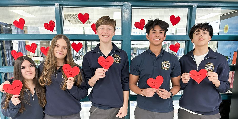 Photo of Bishop Allen students with the heart messages they crafted and wrote