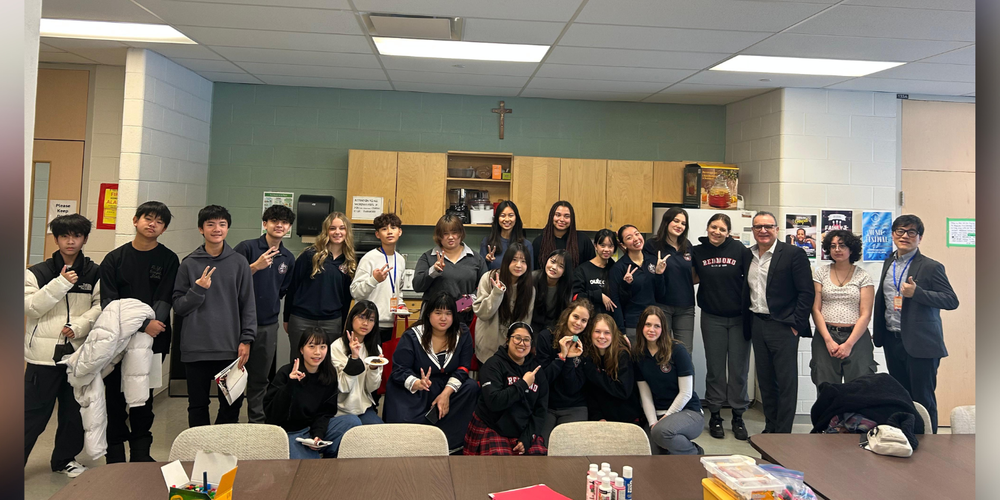 Group of students and faculty in a classroom.