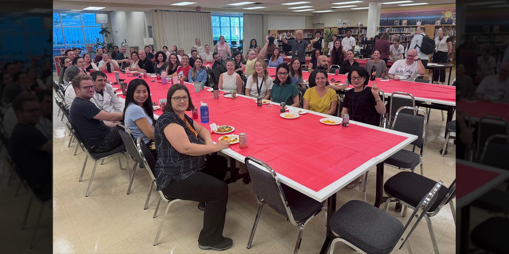 Photo of St. Patrick students in front of the food the served to the teachers at the celebration