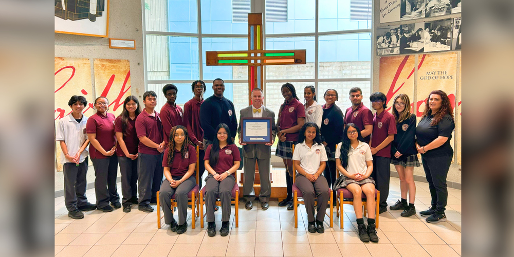 Group of students posing with one faculty member