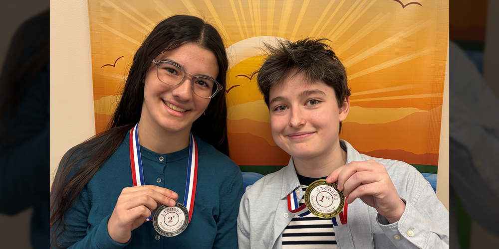 Photo of Olivia and Ash with their medals