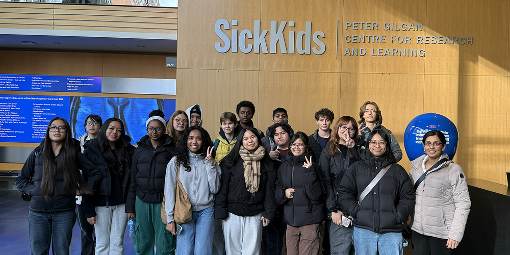 Group photo of St. Patrick students and staff in front of the SickKids Hospital Peter Gilgan Centre for Research and Learning