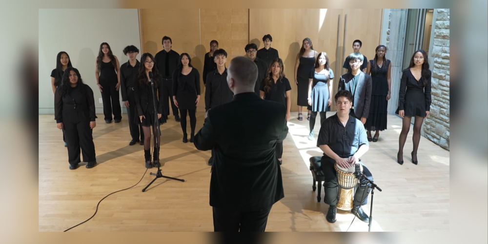 A choir dressed in black performing
