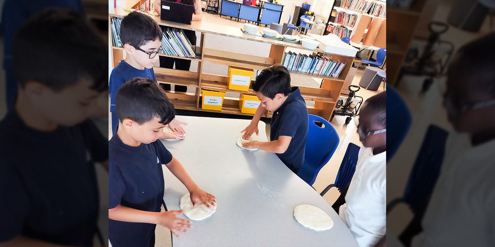 Photo of students making the pizzas