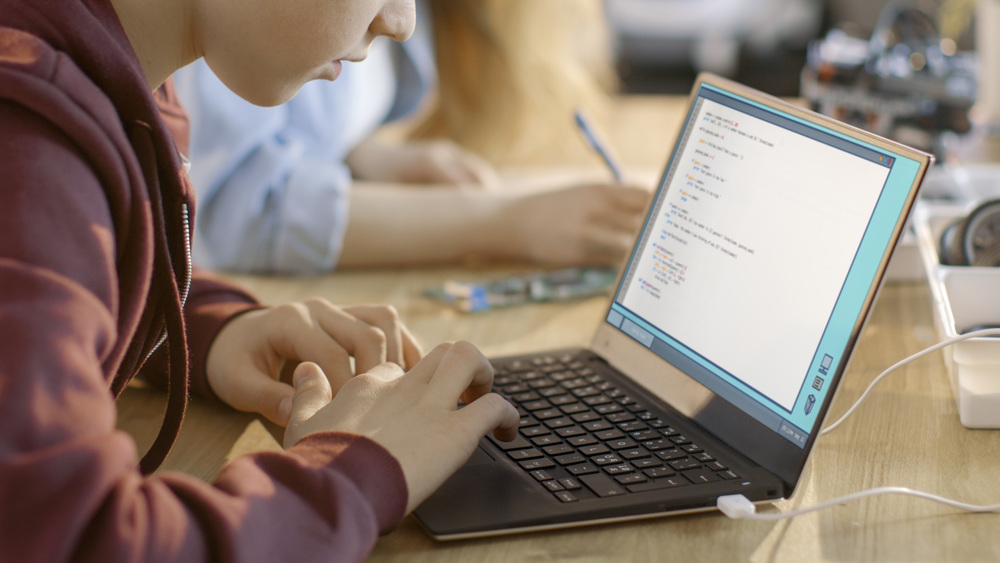 An image of a student typing a laptop.