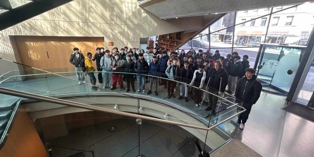 Large group of young adults in a  museum
