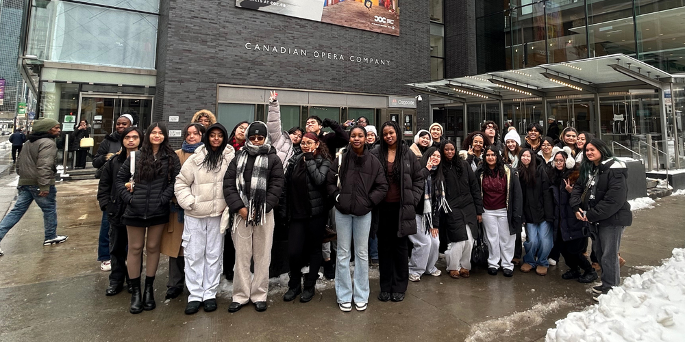 Large group of students posing outside in front of the Canadian Opera Company