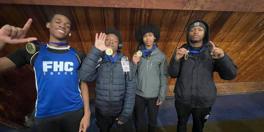 4 students posing with medals