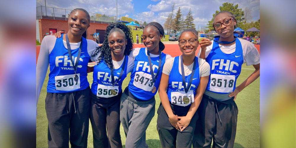 5 students posing outdoors in running jerseys