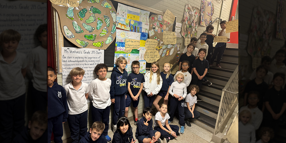 Group photo of OLPH Grade 2/3 class students with their creative work