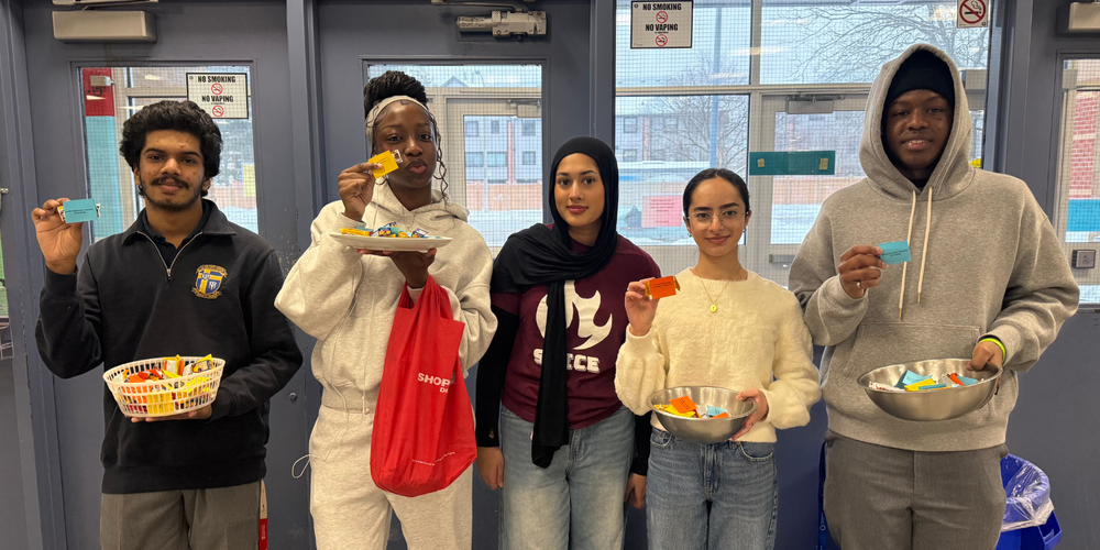 5 students posing with candies